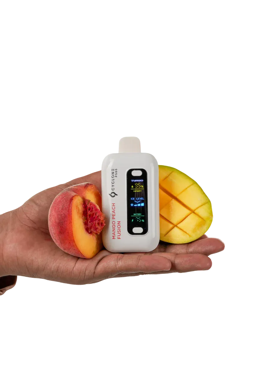 Cyclone Pods Gust Pro Mango Peach Fusion held in hand with fresh fruit